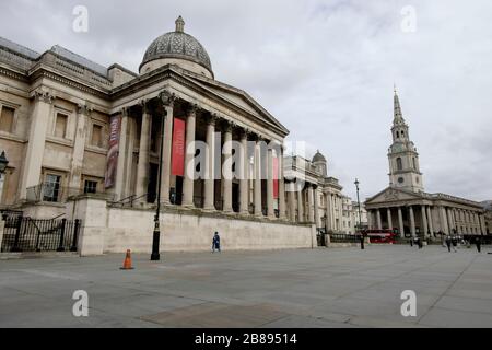 London, UK. 20th March 2020. The area in front of the National Gallery, normally full of visitors, is virtually deserted as people stay away from central London.