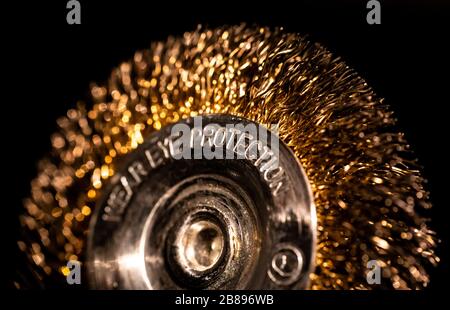 A close-up of power drill metalic golden brush on black background Stock Photo
