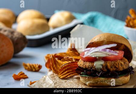 Vegan chickpea burger with sweet potato chips. Stock Photo