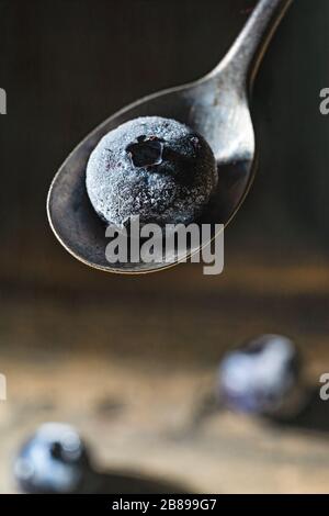 Frozen blueberry on teaspoon. Stock Photo