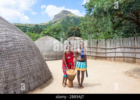 Couple by beehive homesteads at Swazi Cultural Centre, Mantenga Nature Reserve, Lobamba, Ezulwini Valley, Kingdom of Eswatini (Swaziland) Stock Photo