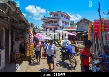 Soanierana Ivongo, Madagascar, Africa 01/08/20: African black people walking in the chaotic and dusty street of a small coastal town, colorful relax Stock Photo