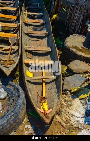 A closeup of a hand carved wooden canoe. Brown, strong and long pirogue made from wood by a local african artisan, ideal for daytrips and fishing trip Stock Photo