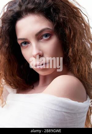 Close-up portrait of the serious young woman with curly hair Stock Photo