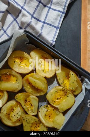 Baked potatoes and cheese in baking tray Stock Photo