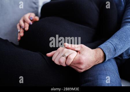 couple is expecting pregnancy in expectation of baby holding hands Stock Photo