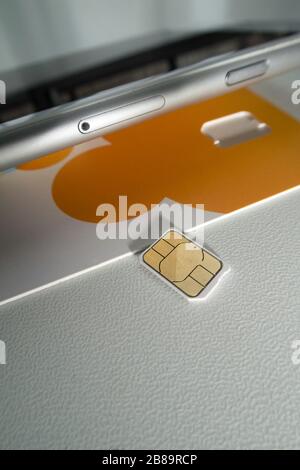 Close Up SIM Card and Cell Phone, USA Stock Photo