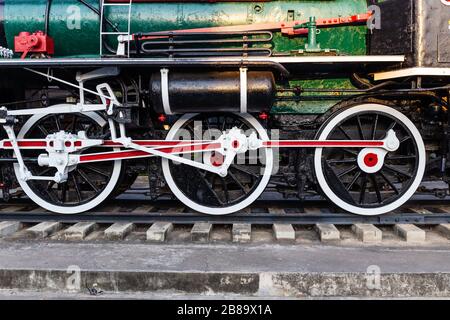 Old train wheels on rails in black, red and white. Stock Photo