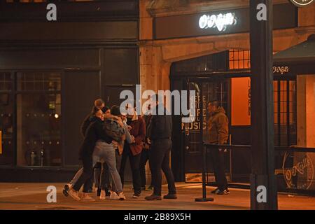 People outside O'Neills pub, in Clapham, London. One of the few open pubs as Prime Minister Boris Johnson orders pubs and restaurants across the country to close tonight as the Government announced unprecedented measures to cover the wages of workers who would otherwise lose their jobs due to the coronavirus outbreak. Stock Photo