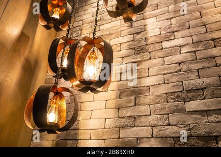 Decorative antique edison style filament light bulbs on brick wall background. Copy space background Stock Photo
