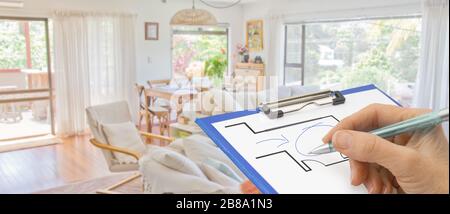 Home improvements renovation banner with architect hand drawing plan design on clipboard in lounge of home Stock Photo