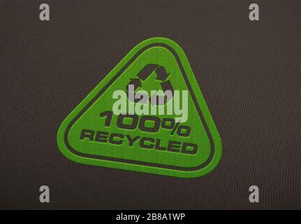 Recycle logo embroidered on cloth background. Stock Photo