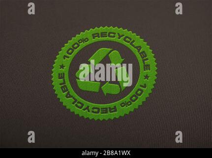 Recycle logo embroidered on cloth background. Stock Photo