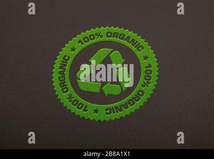 Recycle logo embroidered on cloth background. Stock Photo