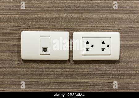 Wall socket and telephone wall socket in room for plug or phone jack. Stock Photo