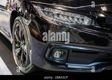 Close up of detail on one of the LED headlights modern and luxury black car. Select focus. Stock Photo
