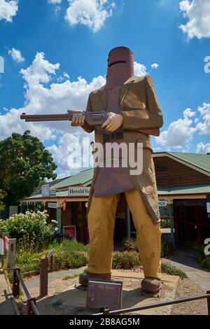 A giant sized sculpture of the outlaw Ned Kelly, in armor and holding a rifle. In Glenrowan, Victoria, Australia. Stock Photo