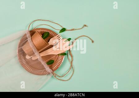 Zero waste, environmentally friendly, disposable, cardboard, paper utensils on a blue background. View from the top. Stock Photo