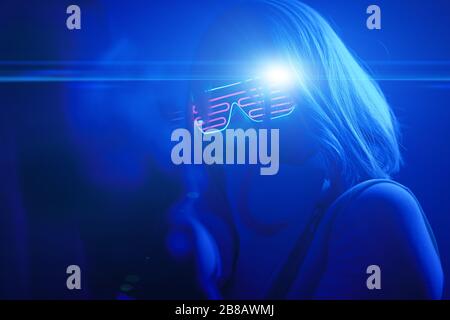 Girl with blaster in the futuristic battle. Concept virtual reality, cyber game and science fiction. Stock Photo