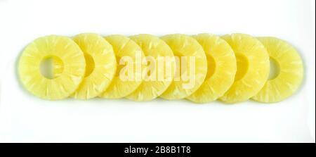 Pineapple rings. Pineapple slice isolated on white background. Canned pineapple. Flat design. Top view. Stock Photo