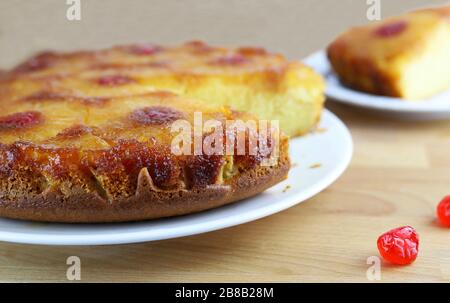 Homemade baking. Pineapple upside down cake with glacé cherry on wooden table.Top view. Stock Photo