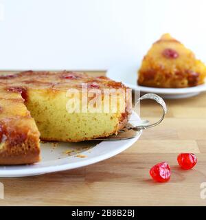 Homemade baking. Pineapple upside down cake with glacé cherry on wooden table.Top view. Stock Photo
