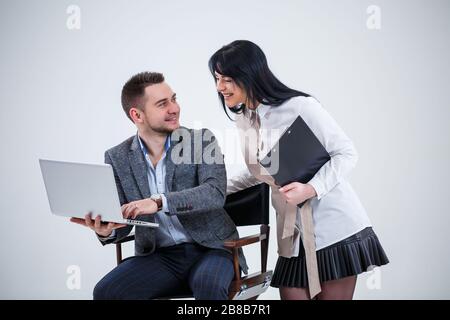 Teacher mentor boss consultant talks about a new online project for a young female student intern, focused leader, executive manager, teaching student Stock Photo