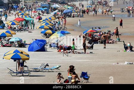 People enjoy the sun during a spring break at Daytona Beach after Florida Governor Ron DeSantis refused to order the state's beaches closed as the number of COVID-19 cases increases across the state. Local officials have closed other Florida beaches, including those in Miami, Ft. Lauderdale, and Tampa. Stock Photo