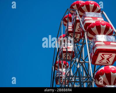 Amusement ride against blue sky. Skydiver (Ferris wheel) in a amusement park in Bucharest . Stock Photo