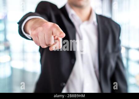 Boss giving order or firing employee. Powerful business man pointing camera with finger. Angry executive or manager. Tough leadership. Stock Photo