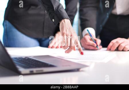 Business people having discussion. Professional woman and man working together in office. Consultant and advisor giving instructions. Stock Photo