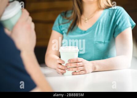 Woman and man having coffee together. People talking and meeting in cafe. Blind or first date. Dating or friendship concept. Stock Photo