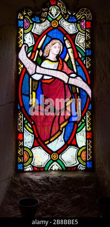 Stained glass window Washbrook church, Suffolk, England, UK c 1870 by Ward and Hughes, angel holding scroll Stock Photo