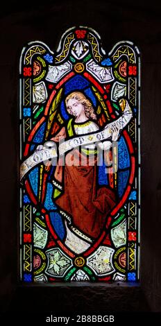 Stained glass window Washbrook church, Suffolk, England, UK c 1870 by Ward and Hughes, angel holding scroll Stock Photo