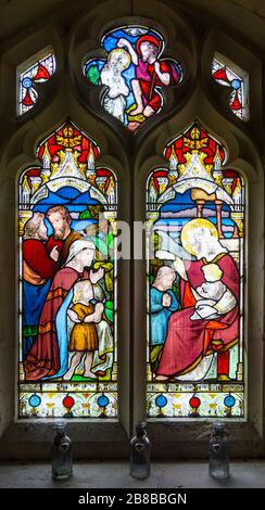 Stained glass window Washbrook church, Suffolk, England, UK c 1870 by Ward and Hughes, Suffer the Little Children Stock Photo