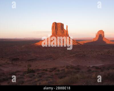 Monument Valley sunset - nationalpark viewpoint at visitor center with West mitten butte & East mitten butte in Utah / Arizona / Navajo tribe reserve Stock Photo
