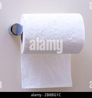 Toilet paper roll hanging under the roll Stock Photo