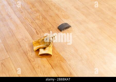 Sanding a floor with a sanding block, home improvement DIY project, UK Stock Photo