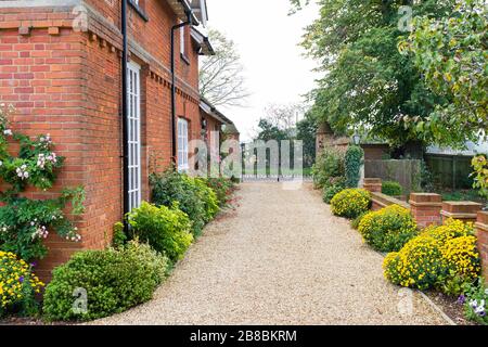 Large English country mansion house from Victorian period in the UK, with wrought iron gates and gravel drive. Stock Photo