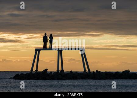 'Couple' a sculpture installed off the coast of Newbiggin-by-the-Sea by the artist and sculptor, Sean Henry, Northumberland, England Stock Photo