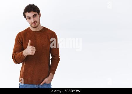 Nice job, well done. Proud and satisfied good-looking bearded man show thumb-up to praise great result, congratulating with awesome work, smiling as Stock Photo