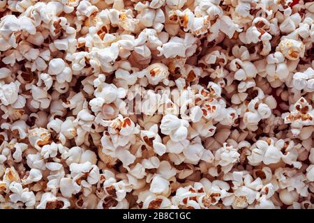 Heap of popcorn background. Close up macro top view. Stock Photo