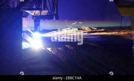 Industrial Laser cutting processing manufacture technology of flat sheet metal steel material with sparks. Stock Photo