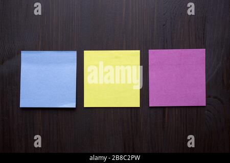 collection of various empty colorful sticky notes paper note on wooden background Stock Photo