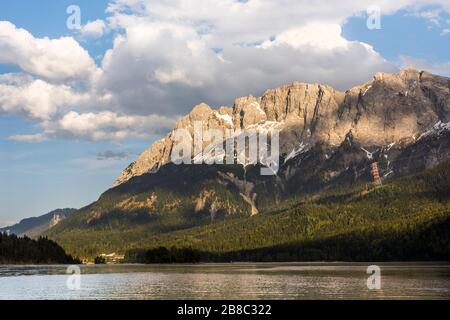 Germany's highest mountain Zugspitze in front of lake Eibsee in the Wetterstein Mountains south of the town Garmisch-Partenkirchen, Bavaria, Germany Stock Photo