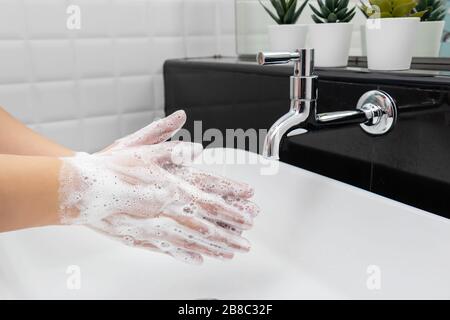 personal hygiene. washing hands, rubbing hand thoroughly with soap that has a lot of bubbles for cleaning and disinfection, prevention of spreading of Stock Photo