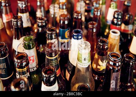 February, 2020 - Ankara, Turkey: Variety of empty beer bottles. Close up high angle view. Stock Photo