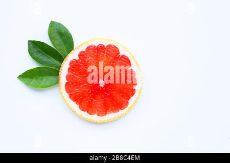 High vitamin C. Juicy grapefruit slices with leaves on white background. Stock Photo
