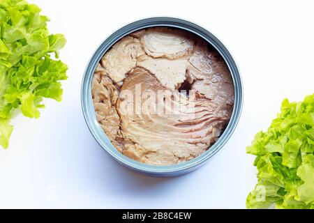 Canned tuna fish  with green oak leaves on white background. Stock Photo