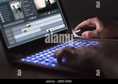 Video editing with laptop. Professional editor adding special effects or color grading footage for commercial film or movie. Man using software. Stock Photo